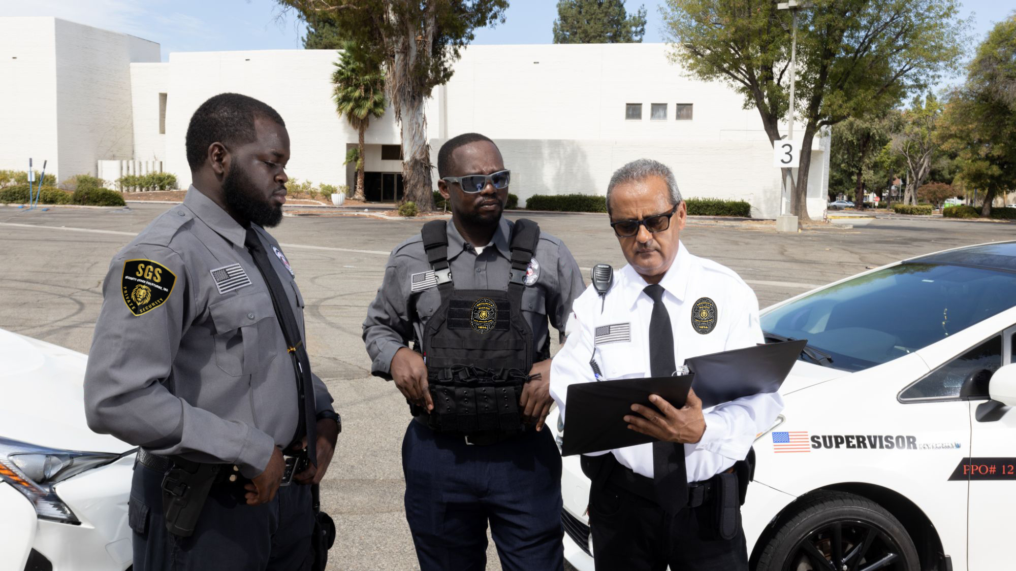 Security officer giving instructions to two security guards